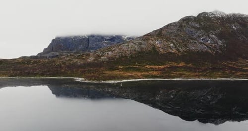 Drone View of Reflecting Lake Water and Rocky Mountains in Lofoten Islands Norway