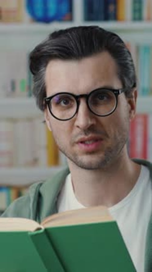 A Thoughtful Man Reading a Captivating Book in a Cozy Library Filled with Countless Books