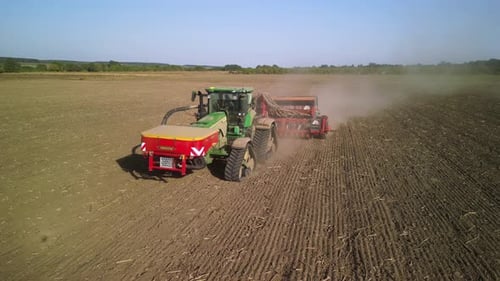 Tractor on the field seeding wheat
