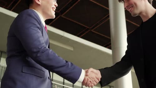 Closeup hands of businessman handshake with partner at office.