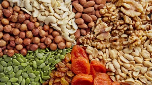 Assortment of Dried Fruits and Nuts Rotating Natural Food Background