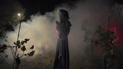 Monk With Monster Face Walk in the Night Forest for Halloween