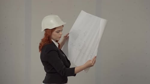 Side View of an Architect Woman Holding a Plan of a Building in Her Hands A Business Woman is