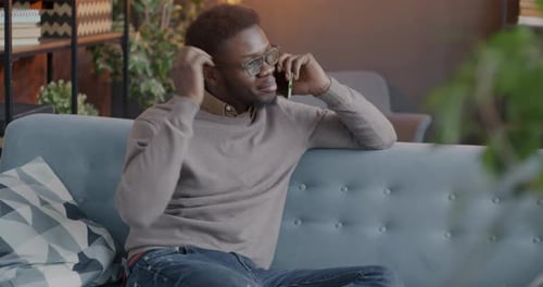 Young Adult Man Talking on Phone Indoors