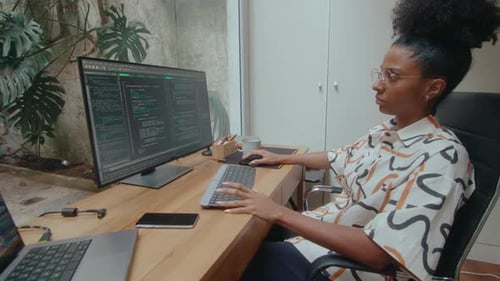 Young Woman Coding on Computer in Home Office