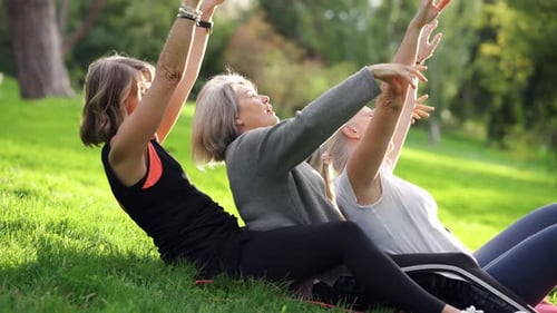 Senior Women Friends Practicing Group Exercise Together in a Park