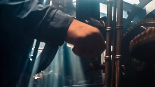 Person Winding A Wheel Inside Of A Clock