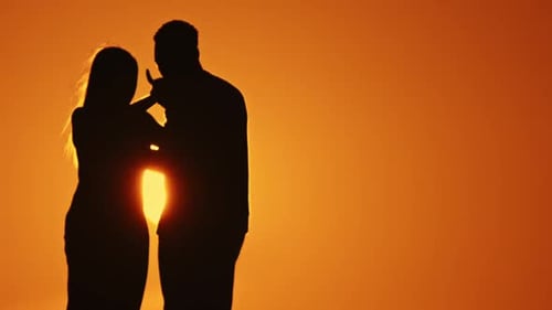 Romantic Couple Silhouette Embracing at Sunset