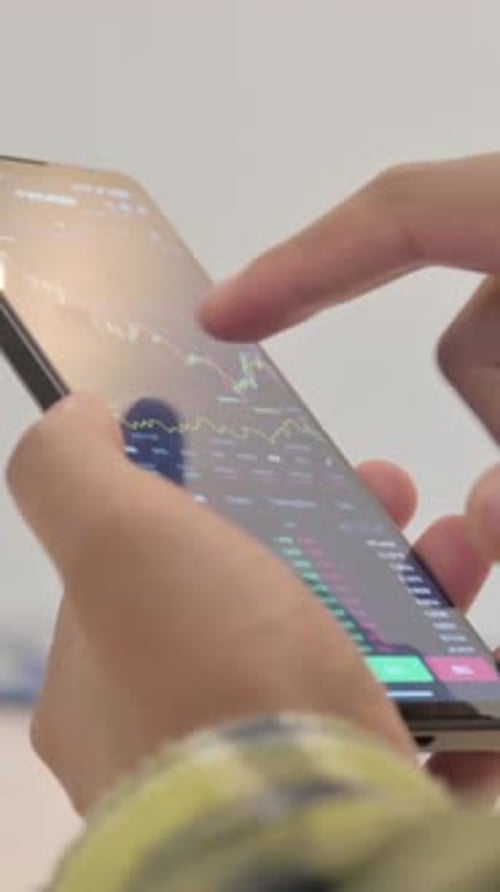 Close up of African Man Trading on Smartphone, Financial Graph, Vertical Video