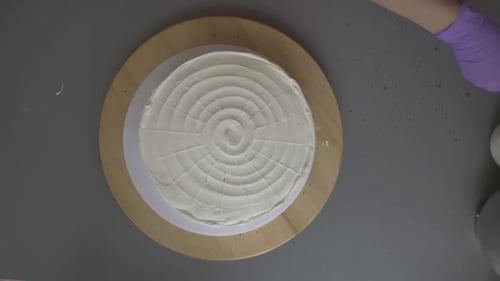 Woman Decorating Red Velvet Cake with Crumbles