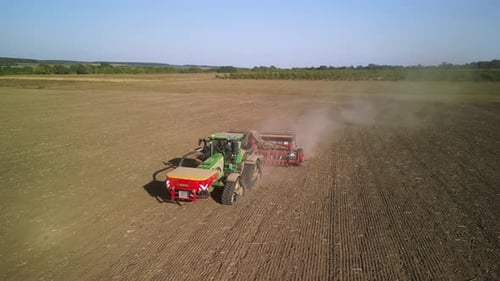 Tractor on the field seeding wheat