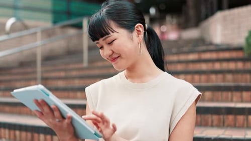 Business, steps and tablet with Japanese woman outdoor in city for break, email or research