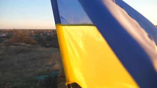Yellow and Blue Flag Waving at Sunset