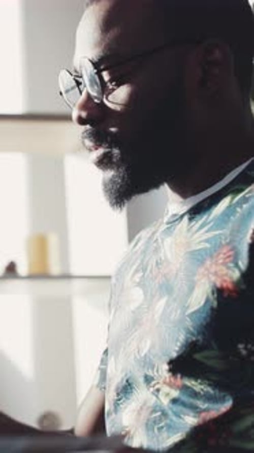 A Thoughtful Man Enjoying Natural Light in a Cozy Indoor Setting Capturing the Moment