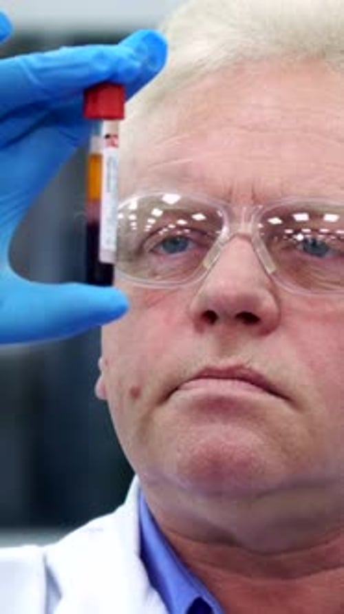 Scientist Examining Blood Sample in Medical Lab