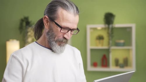 Senior Man Using Laptop at Home