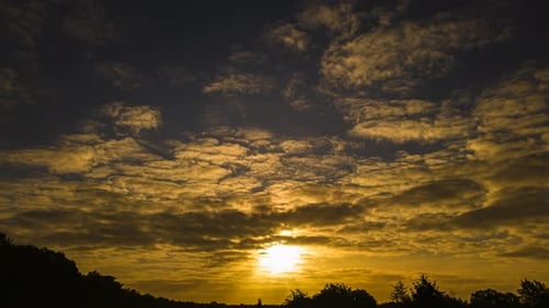 Brilliant Sunrise Golden Light Through Altocumulus Clouds