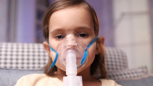 Child Using Nebulizer Mask for Respiratory Treatment