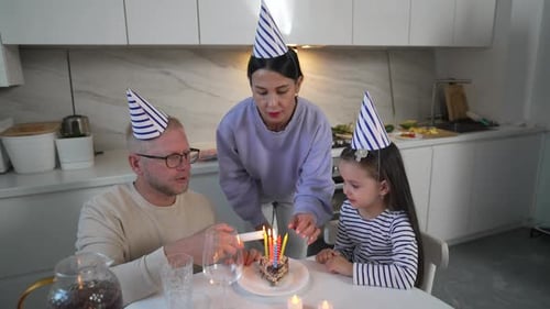 Family Lights Birthday Candles in Modern Kitchen