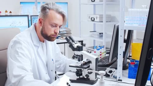 Scientist Using Microscope in Bright Laboratory