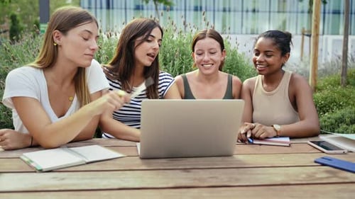Group of Female Student Girl Friends Learning Together Working on Laptop at University Campus