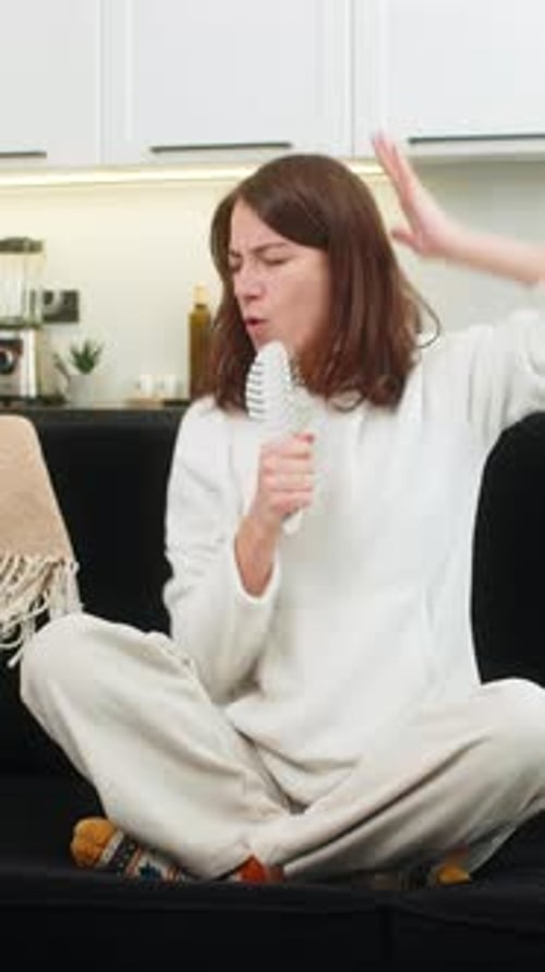 Woman Singing and Dancing with Hairbrush in Living Room
