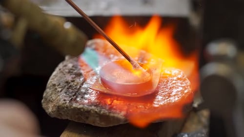 Craftsman Soldering the Tip of the Scabbard in the Workshop