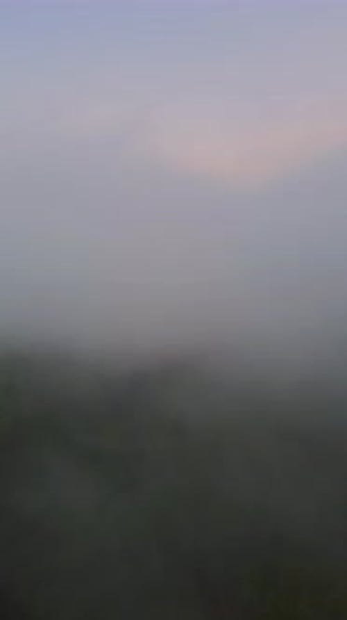Vertical Drone Footage of fog in the mountain at Gorontalo, Indonesia