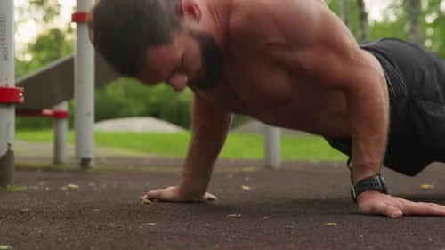 Shirtless Bearded Man Doing Push-Ups in Outdoor Park