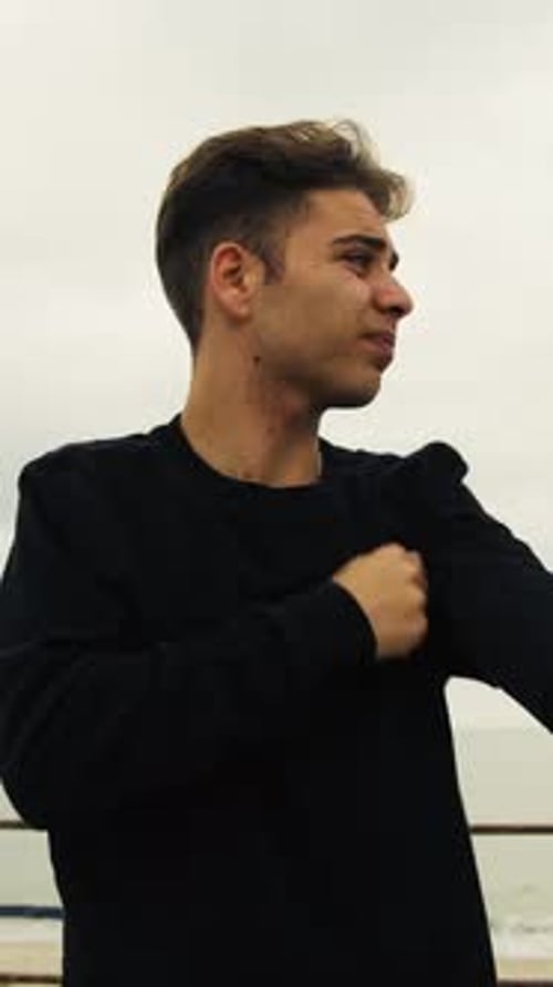 Young Man Talking Outside on Cloudy Day