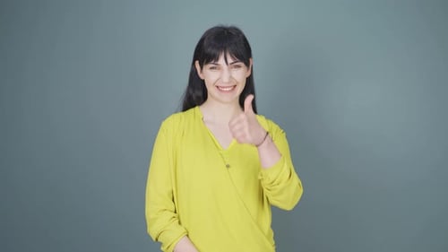 Smiling Woman Gives Thumbs Up and Okay Sign
