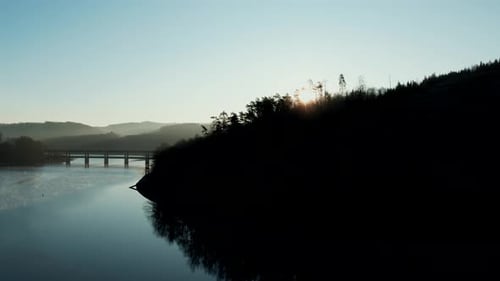Drone Footage Above Bridge and Water at Dusk