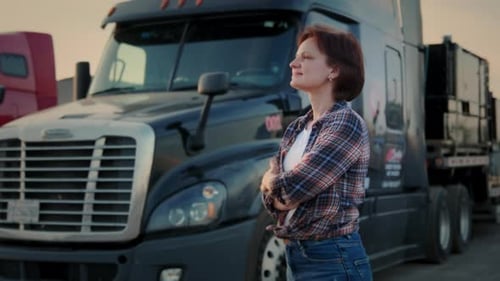 Truck Driver Standing in Front of Semi Truck