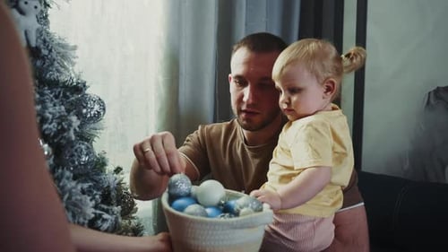Father and Child Decorating Christmas Tree at Home