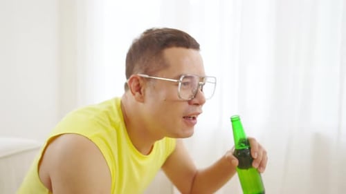 Friends Drinking and Cheering While Watching a Game