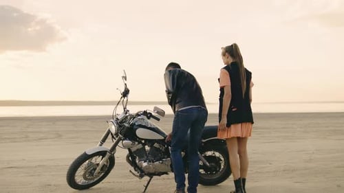 A Couple Leisurely Walks on a Serene Beach at Sunset Enjoying the Tranquil Surroundings