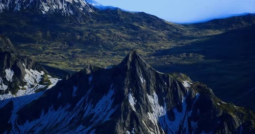 Majestic Mountain Peak Surrounded By Lush Greenery and Snow at Sunset