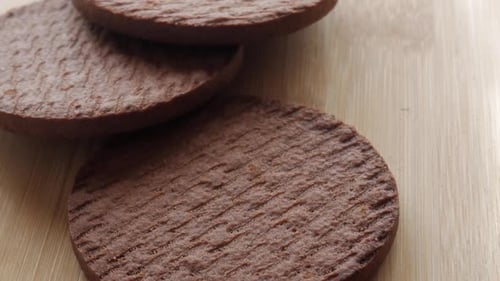 Close-up of soft biscuits stacked on a wooden surface, showcasing the texture