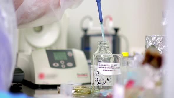 Laboratory Medical Researcher Transfers Liquid with Pipette, Science ...