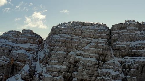 aerial view of a frozen mountain in the alps with detail on rocks and snow