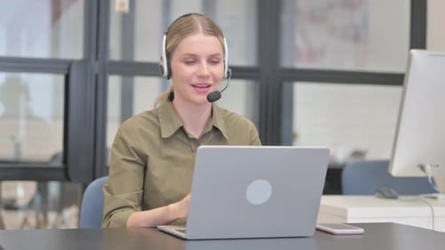 Woman with Headset Talking Online with Customer in Call Center