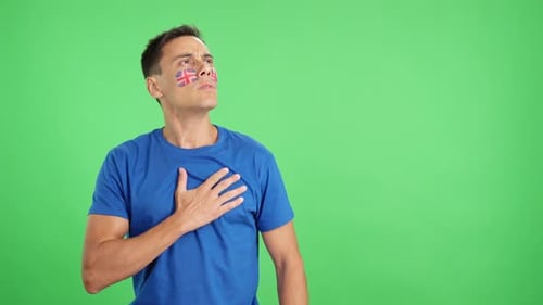 Man Listening to the United Kingdom National Anthem with Solemnity