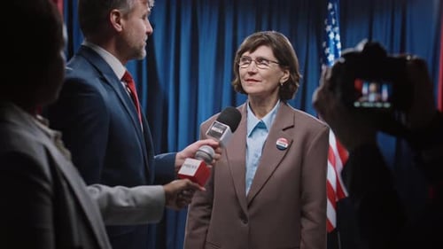 Journalists Interviewing Mature Caucasian Female Politician Running for Senate