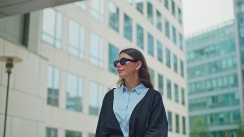 A Beautiful Businesswoman Goes to the Office of a Business Center
