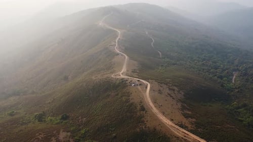 Aerial view of treeless mountain range destroyed by humans.