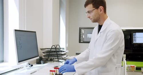 Man Using Computer in Clinic Lab