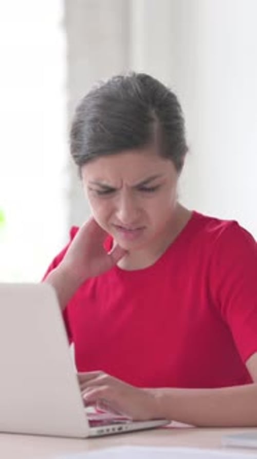 Indian Woman having Neck Pain while using Laptop in Office, Vertical Video
