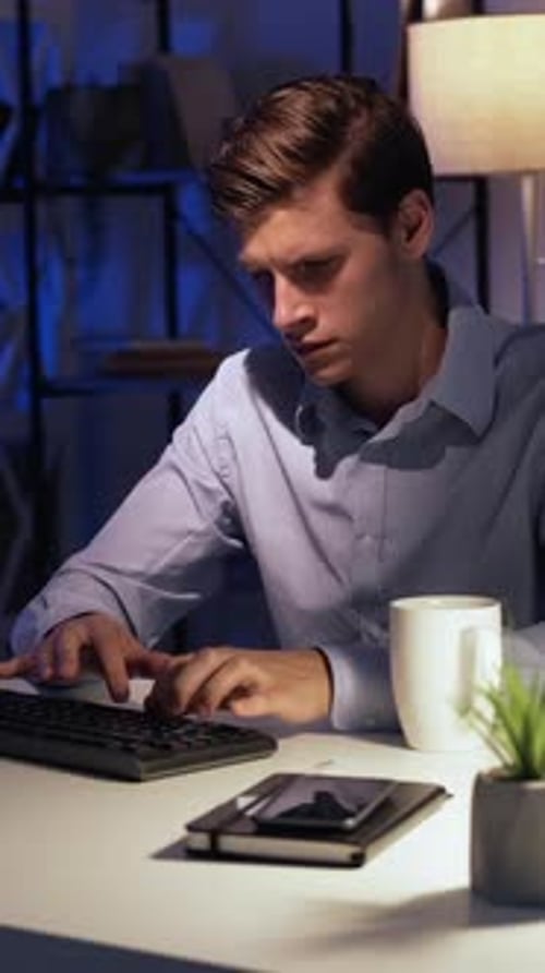 Young Adult Working at Desk at Night