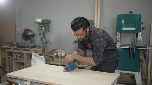 Carpenter is working at workshop.