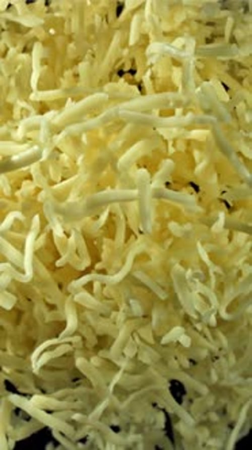 The Grated Cheese Flies Up and Down Filmed on a Highspeed Camera at 1000 Fps